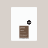 Coffee package labeled 'Colombia Decaf San Agustin' with 'heart' branding on a beige background