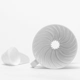 hario v60 (02) ceramic white dripper. with a small cup for measuring. all white background.