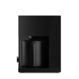 Black coffee machine on a white background. fellow aiden coffee machine. warranty through fellow, no returns on equipment.