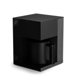 Black coffee machine on a white background. fellow aiden coffee machine. warranty through fellow, no returns on equipment.