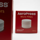 small red box of aeropress filters. 350 replacement AeroPress micro-filters compatible with AeroPress Original, Go &amp; Clear Coffee Maker. pictured on a white background. 