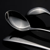 closse up, engraved heart text on bed of spoon.